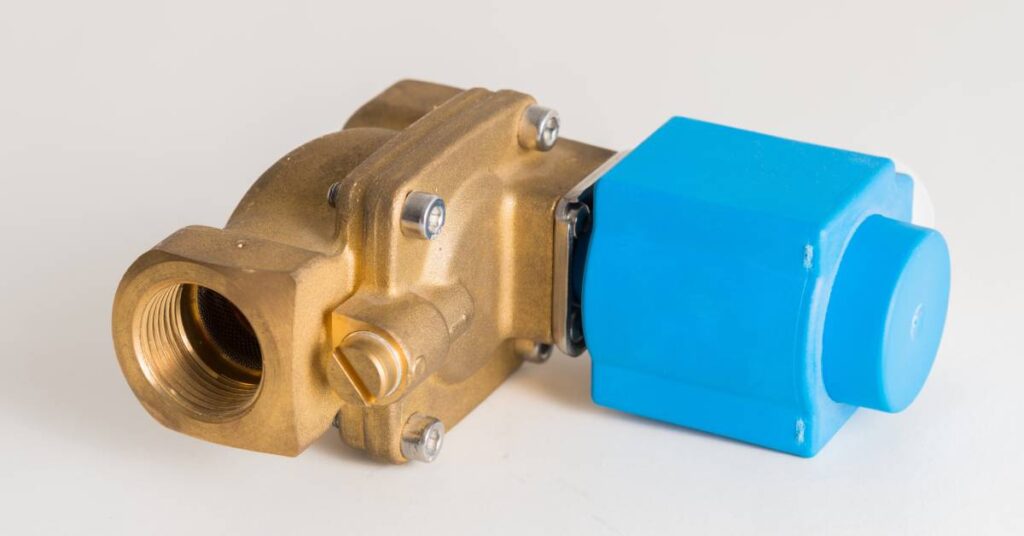 A blue and gold solenoid valve lying on its side in front of a white background. The valve has silver screws.