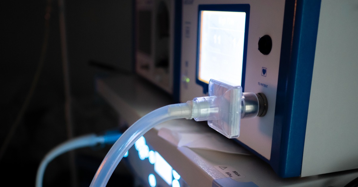 A close-up view shows a laparoscopic insufflator lit up with a clear plastic hose coming out the front.